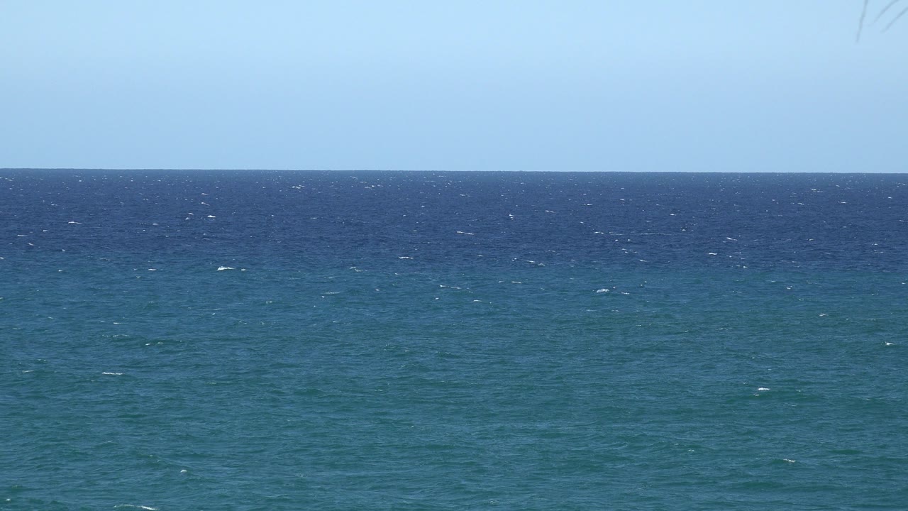At one second, the Grand Junction Colorado 2017 frame holds on open sea with more scattered whitecaps across the middle water band and no visible people.