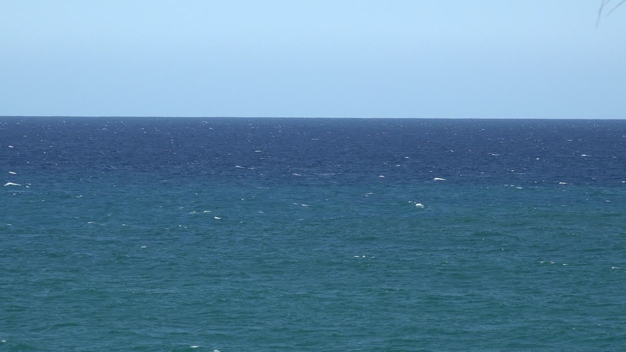 Wide view of textured blue water below a level horizon in the Grand Junction, Colorado 2017 clip, with bright daylight and no visible people.