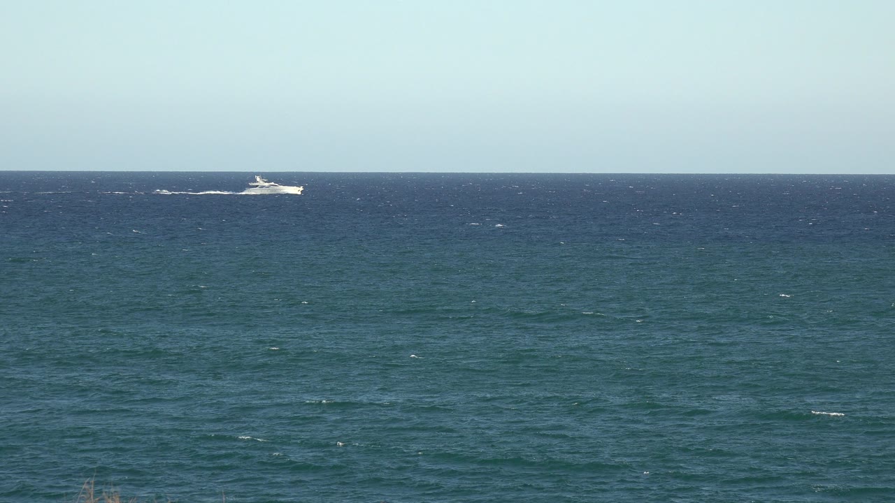 At 0:01, the white boat sits near the horizon over choppy blue-green water in the Grand Junction Colorado 2017 clip, with no visible people.