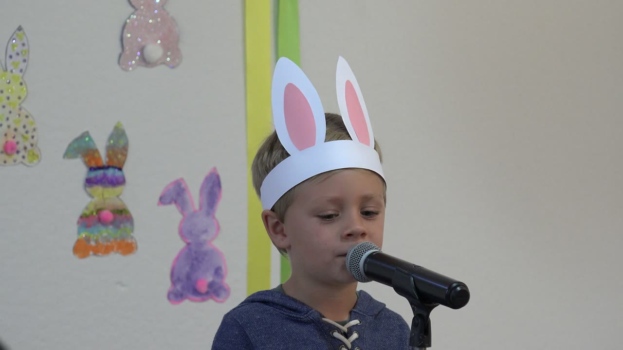 At the start of the Cabo San Lucas, Mexico clip, a young boy in white paper bunny ears faces a microphone with Easter bunny decorations on the wall behind him.