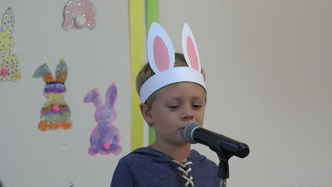 One second in, the boy in Cabo San Lucas, Mexico stands closer to the microphone, with his white bunny ears high against the decorated wall.