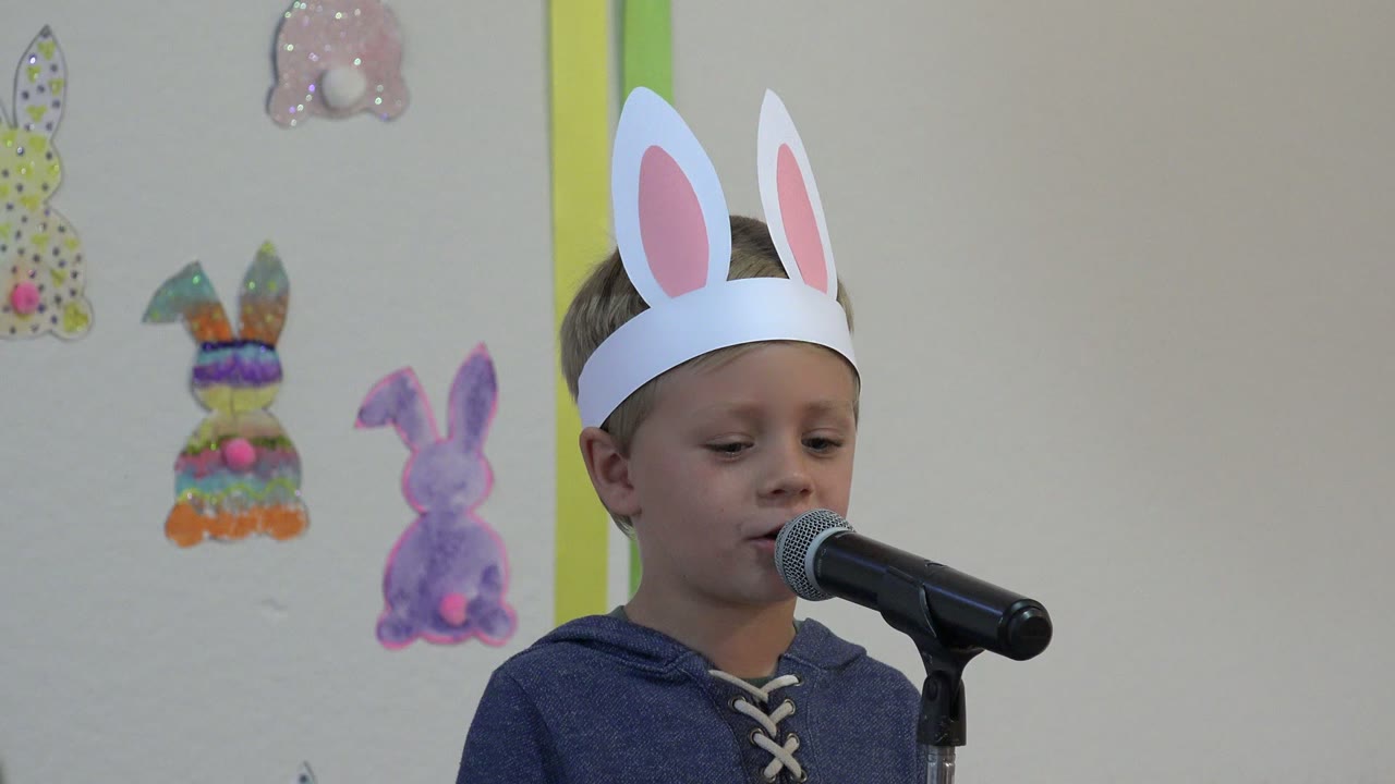 Two seconds into the Cabo San Lucas, Mexico footage, the child keeps his face turned toward the microphone while paper bunny cutouts remain visible behind him.