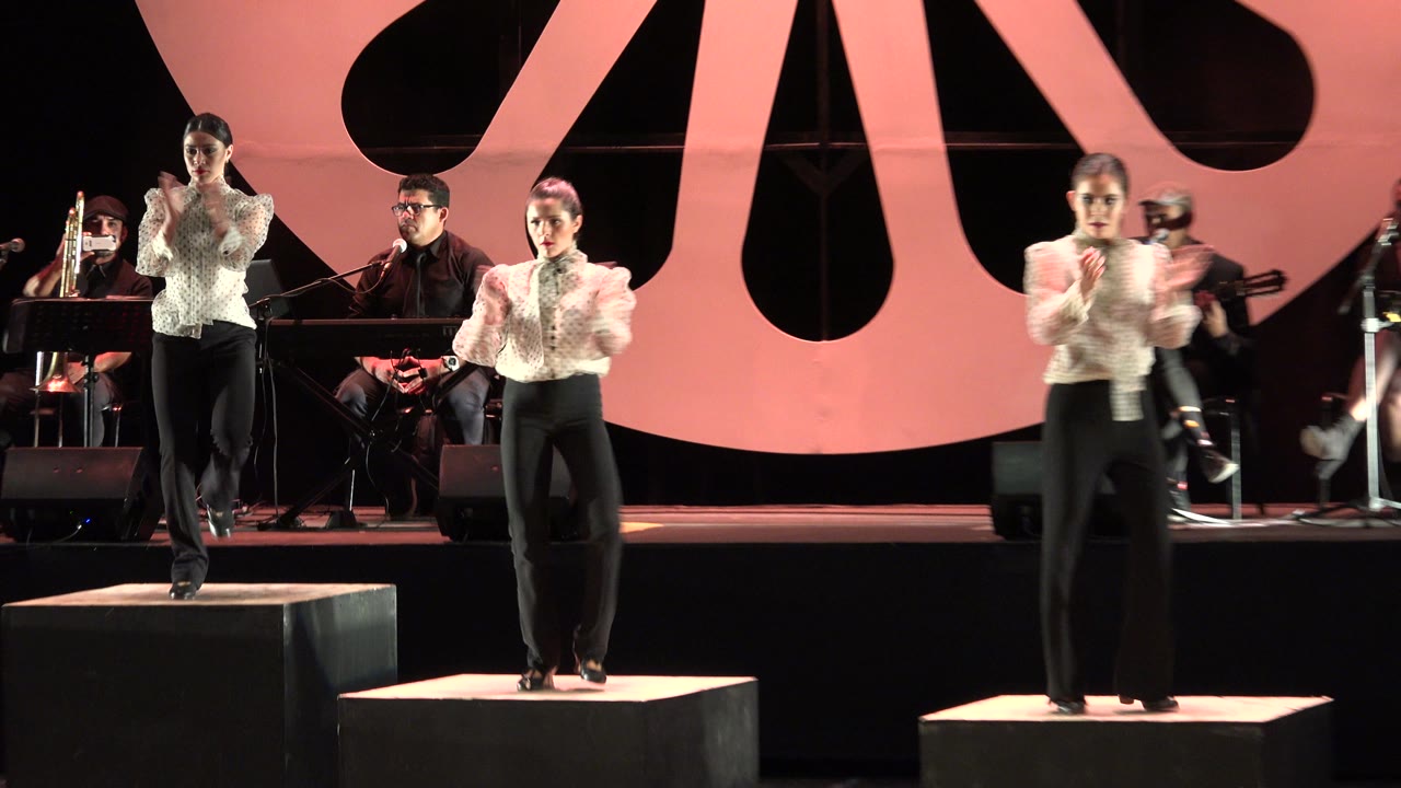 Dancers on stage with musicians behind them