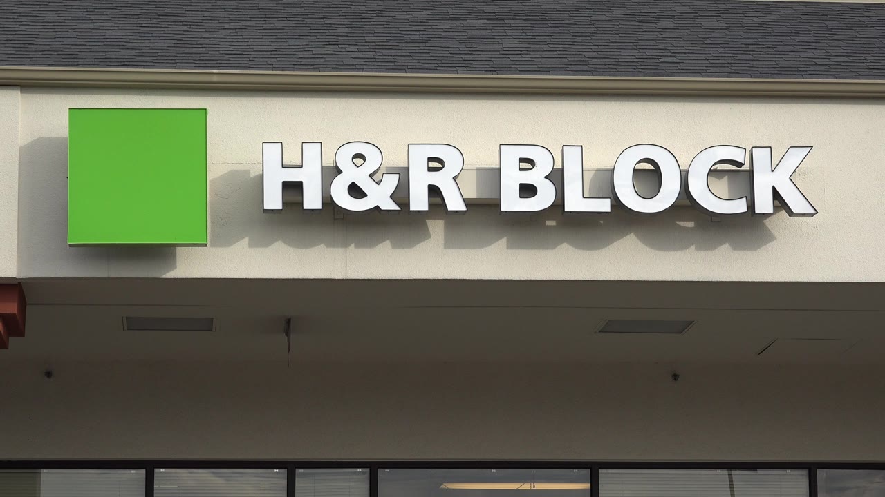 H&R Block sign on a beige storefront facade.