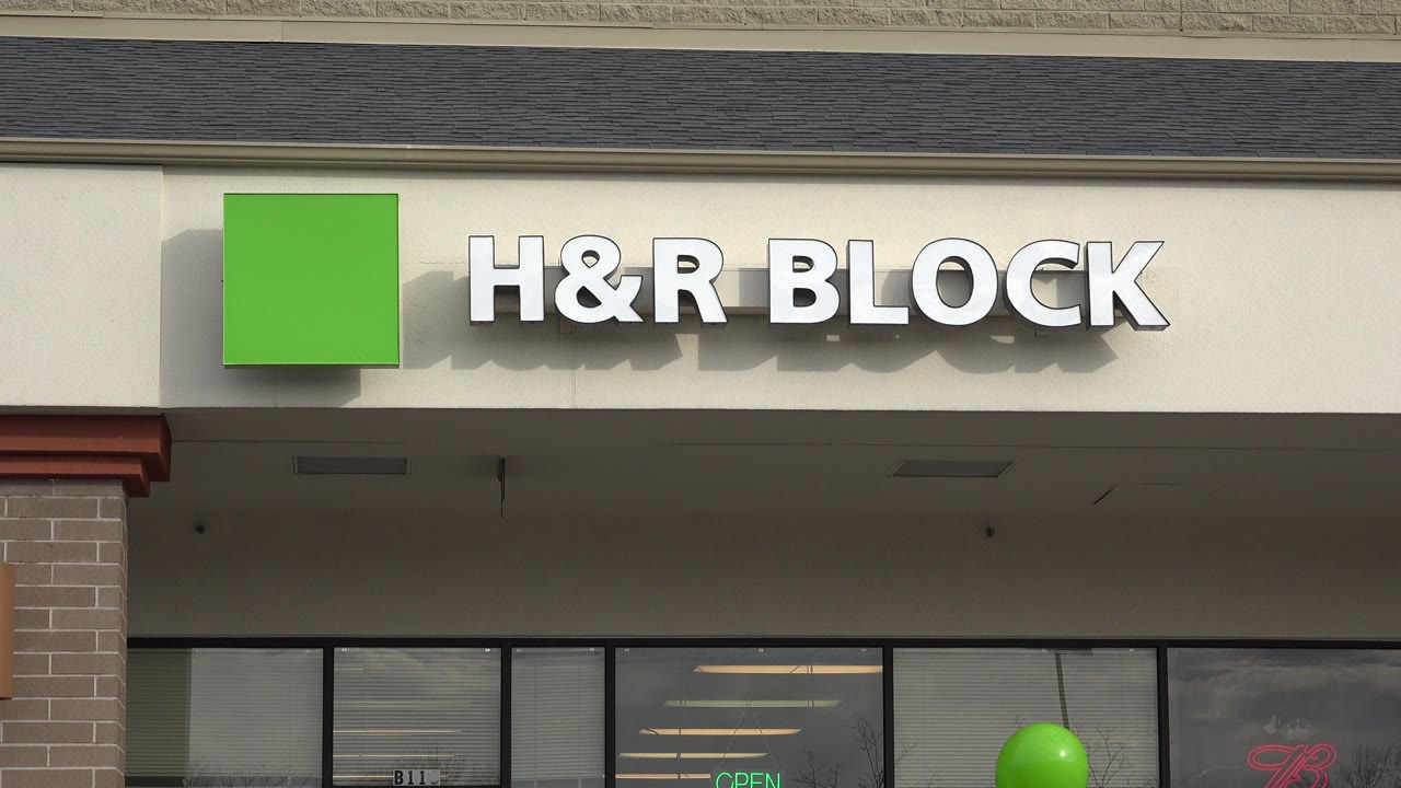 H&R Block sign on a suburban storefront facade.