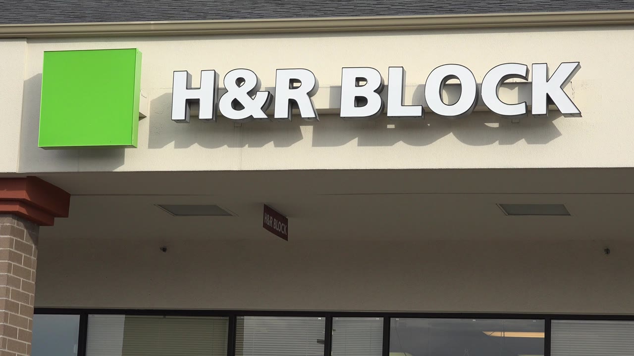 H&R Block storefront sign on a beige retail facade.