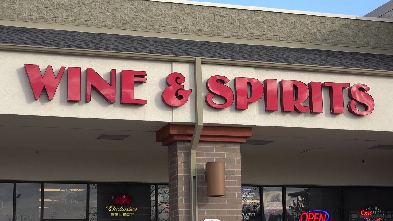 Wine and Spirits storefront sign above dark shop windows.