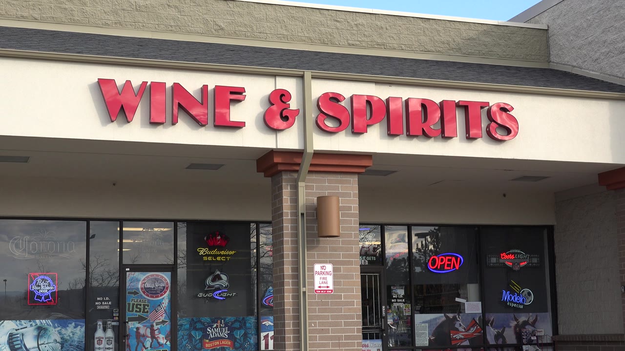 Storefront entrance below a red Wine & Spirits sign.