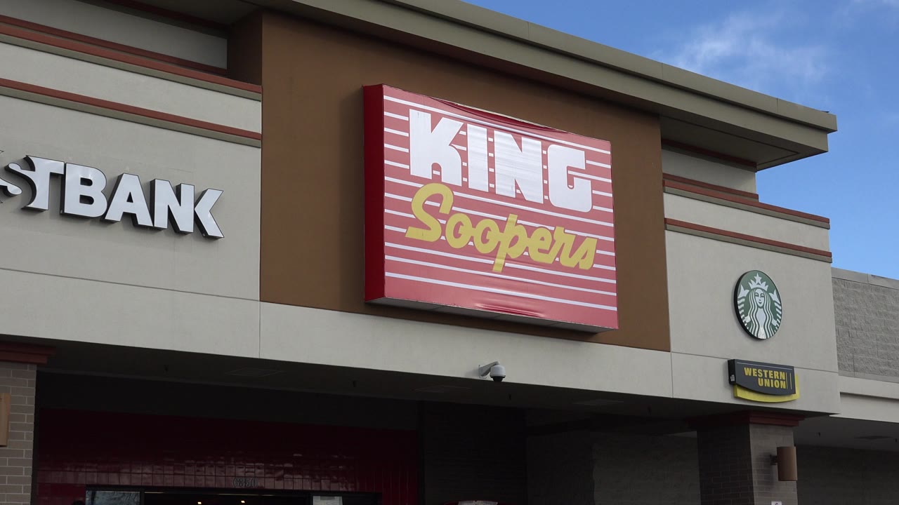 Westminster, Colorado retail frontage one second in, with the 1stBank sign partly cropped at left, the King Soopers sign centered, Starbucks at right, and no visible people.