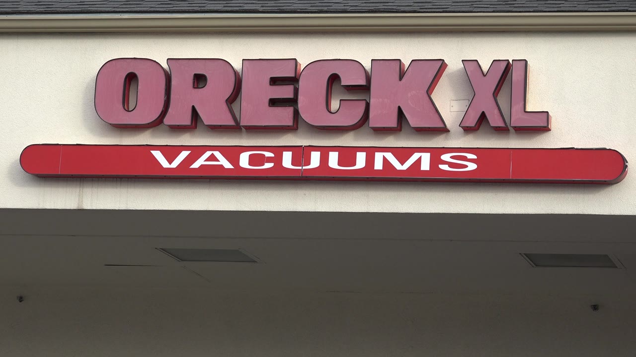 Oreck XL sign above a red Vacuums sign strip.