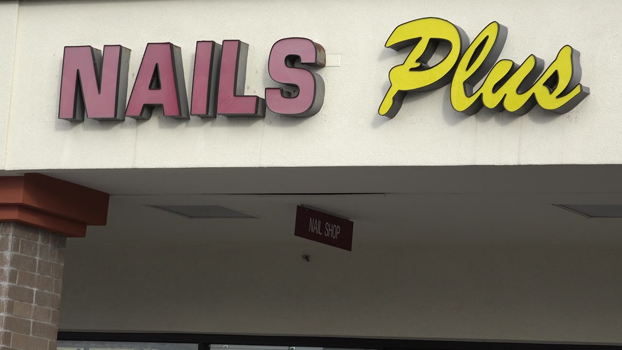 Nails Plus sign above shaded walkway