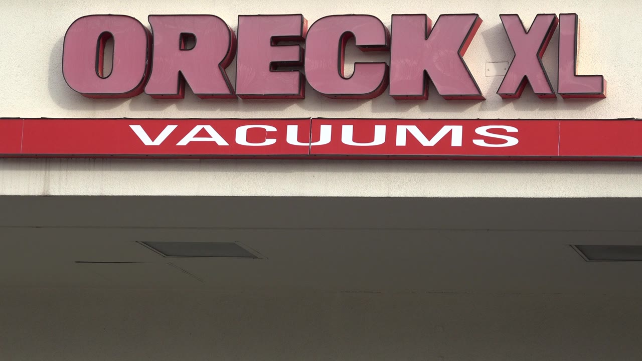 Close view of Oreck XL Vacuums storefront signage.