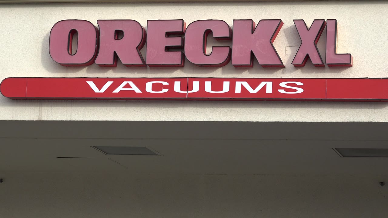 Oreck XL Vacuums sign cropped near the top of the storefront.