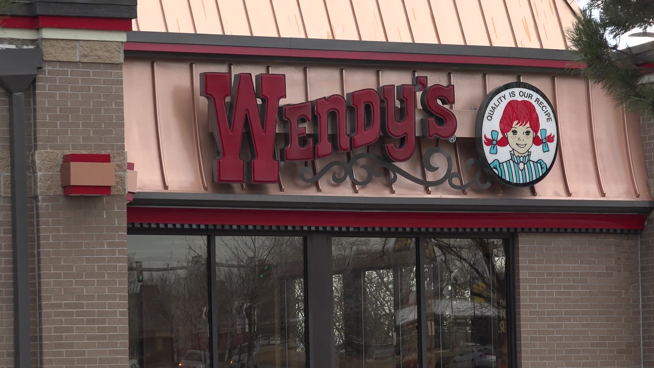 Close view of a Wendy's storefront sign above windows.