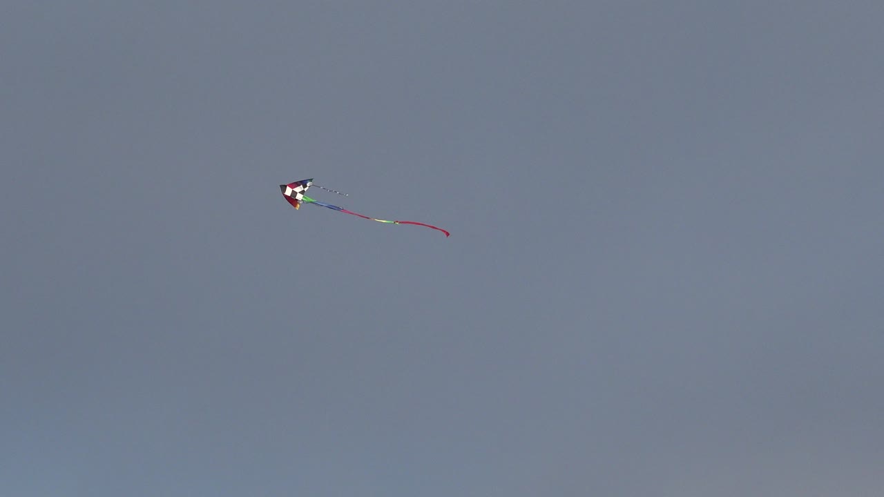 At 0:01, the kite remains small in the open Westminster, Colorado sky while its tail trails to the right, with no visible people.