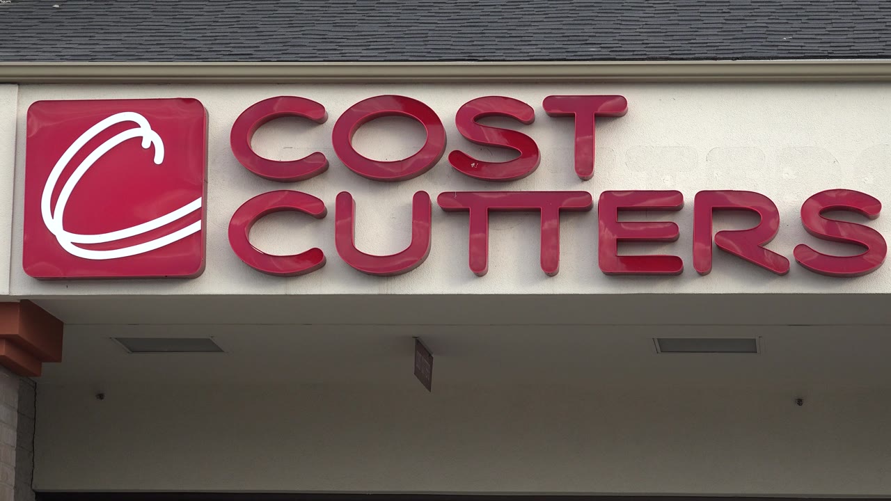 Cost Cutters sign spans the upper storefront beneath a dark roof.