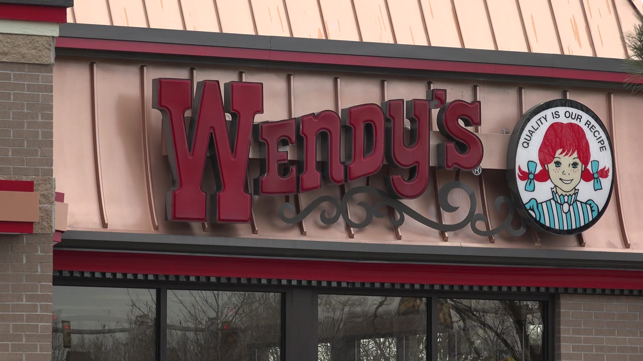 A similar close view centers the red Wendy's lettering and round logo above the window line in Westminster, Colorado, with no visible people.