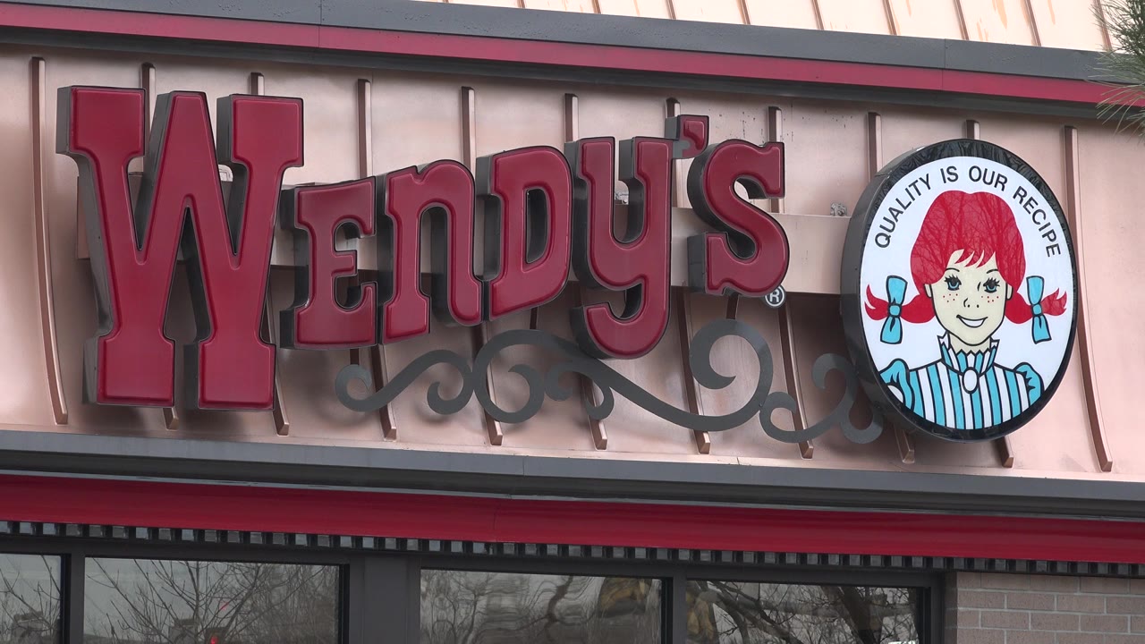 Wendy's facade sign with round logo above windows.