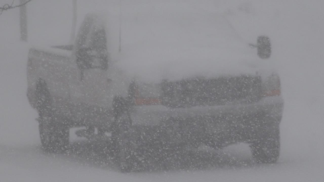 The vehicle remains framed tightly in Westminster, Colorado, with thick snow crossing the grille and bumper area and no visible people.