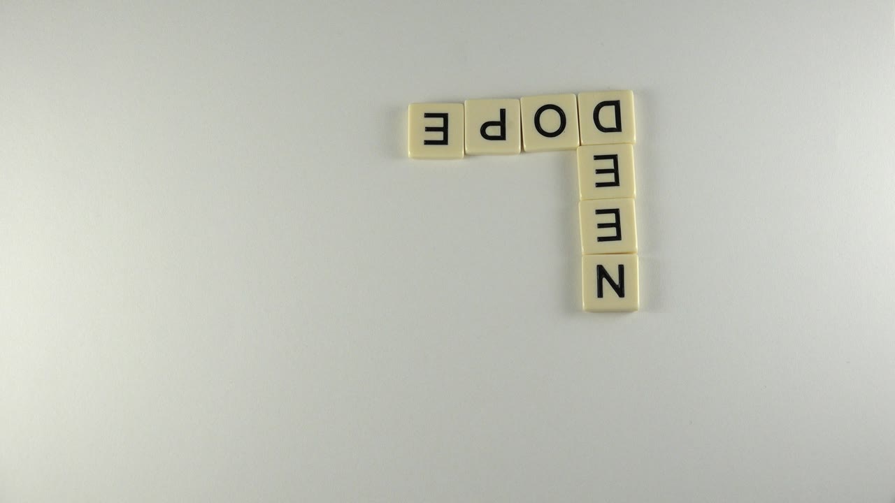 White tiles spelling words in an upside-down L arrangement.