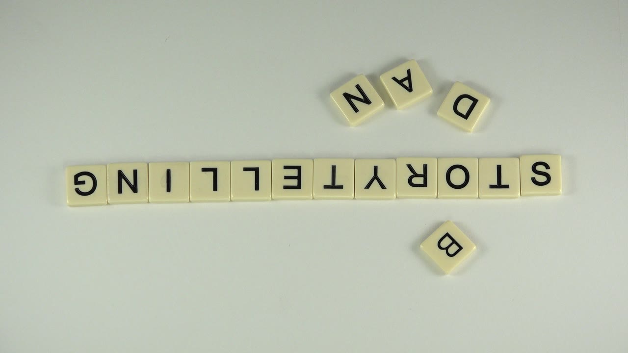 Upside-down letter tiles spelling STORYTELLING with loose tiles above and below.