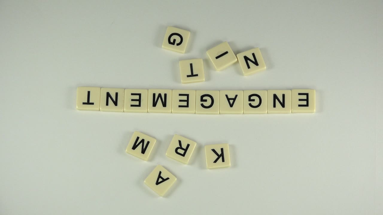 The Westminster, Colorado tabletop view keeps ENGAGEMENT centered, with loose tiles scattered above and below the word and no visible people in the frame.