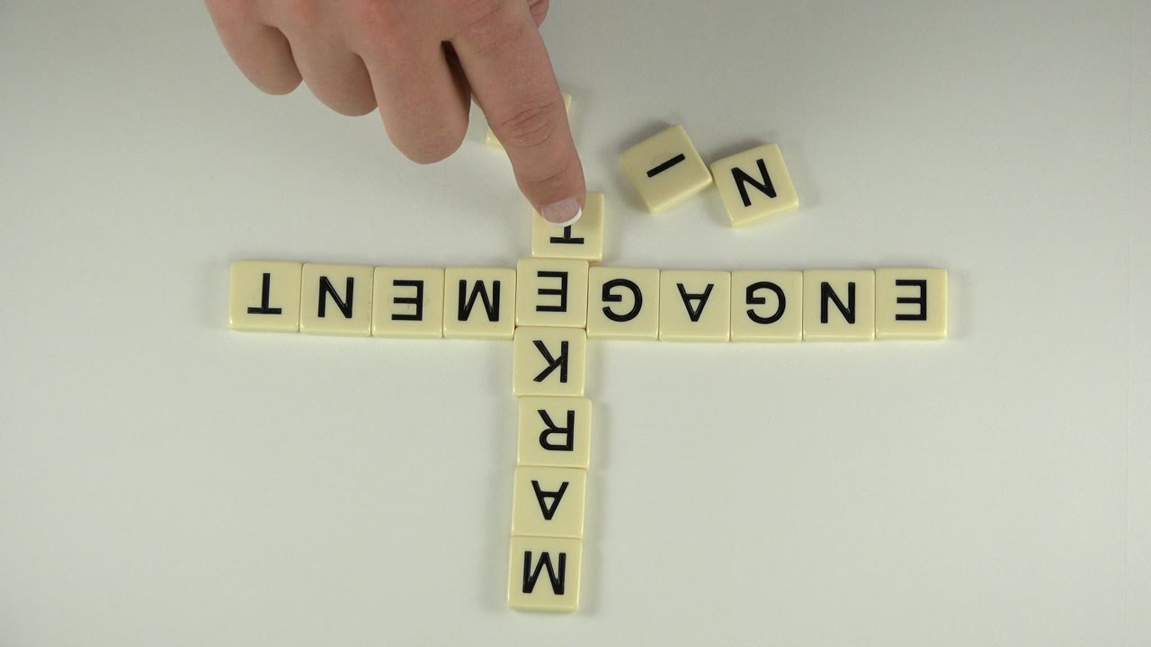 At 0:00 in Westminster, Colorado, a hand hovers over cream letter blocks arranged across a pale tabletop with engagement and marketing visible.