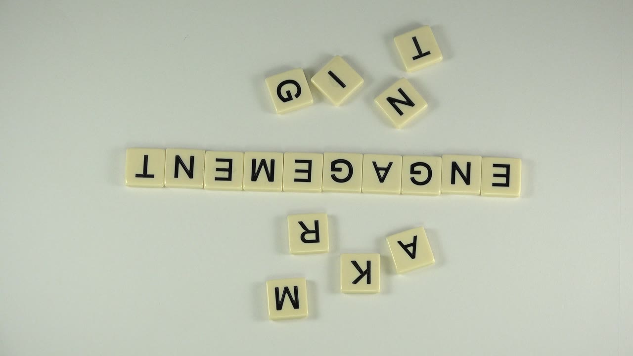 Letter tiles arranged on a pale surface with ENGAGEMENT across the middle.