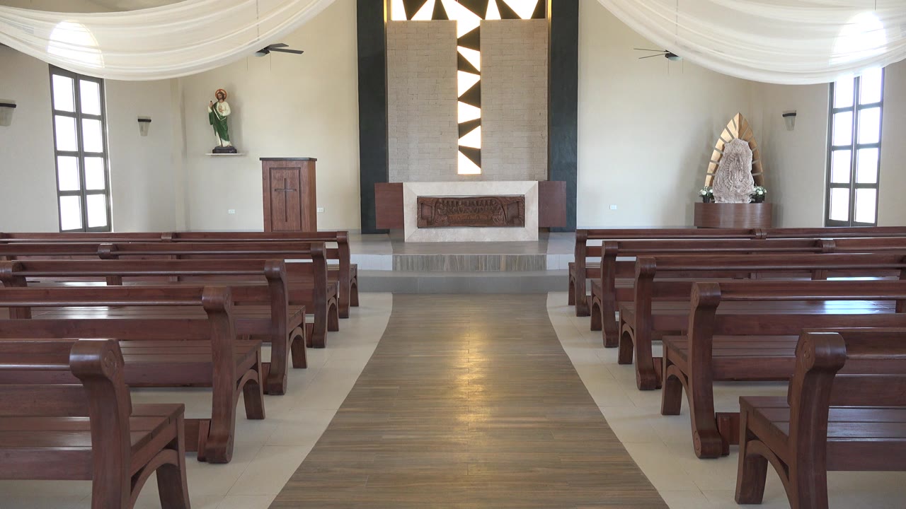 A similar interior view shows the Playa Del Carmen church pews from slightly farther along the aisle, with the altar, side door, and no visible people.