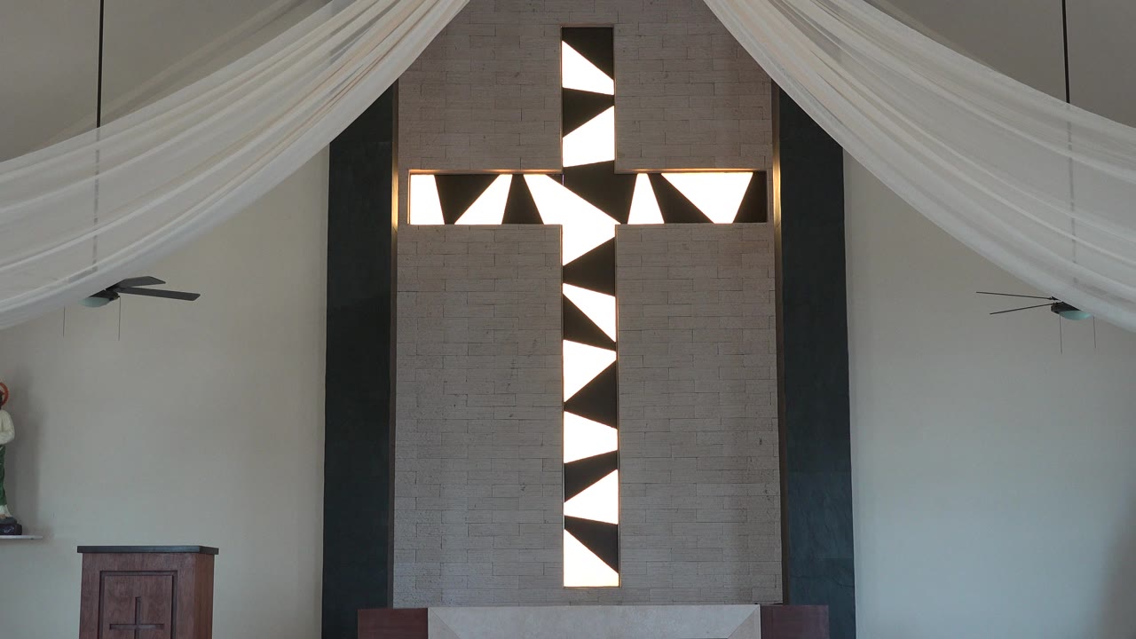 The Playa Del Carmen church interior remains centered on the black and white vertical feature, with the white fabric swag crossing the ceiling and no visible people.