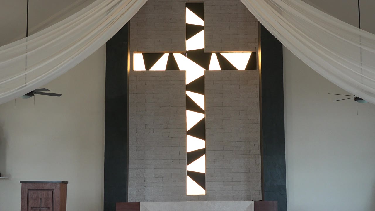 At 0:01, the Playa del Carmen interior view keeps the brown geometric panel central, with sheer white ceiling drapes and a ceiling fan visible, no visible people.