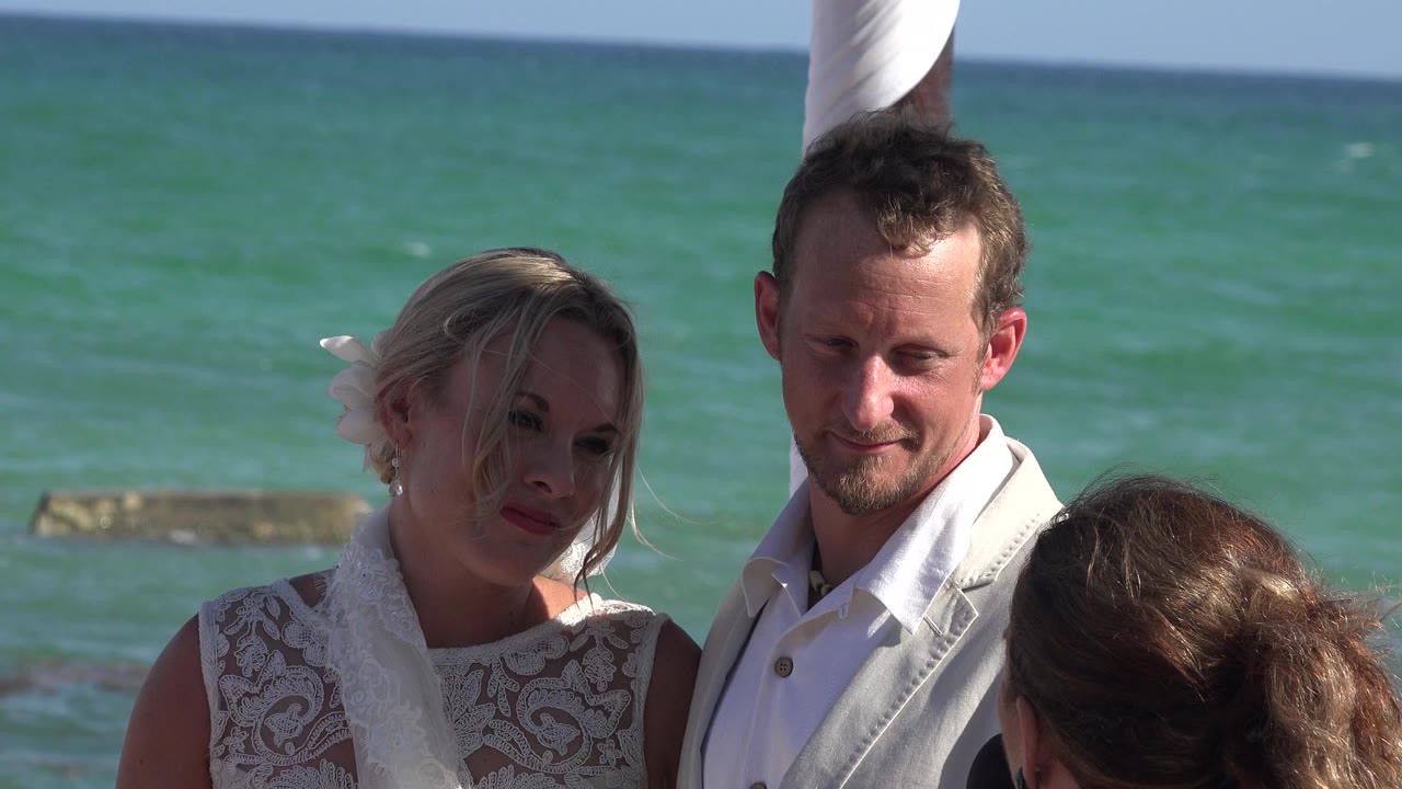 Couple standing close by turquoise ocean water