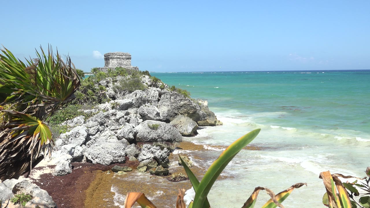 Limestone rocks beside turquoise sea in Tulum