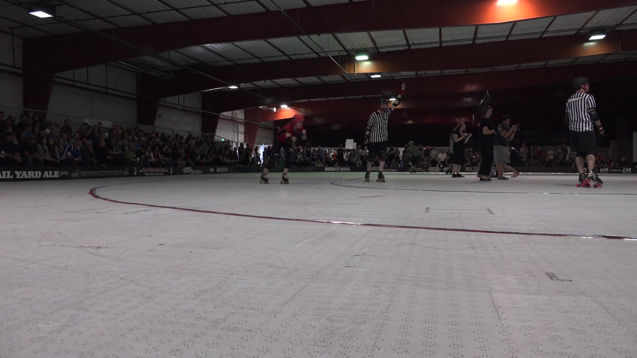 At 0:01, the wide Denver indoor venue view holds on the open floor as a rollerblader moves at left and striped officials stand near the center line.
