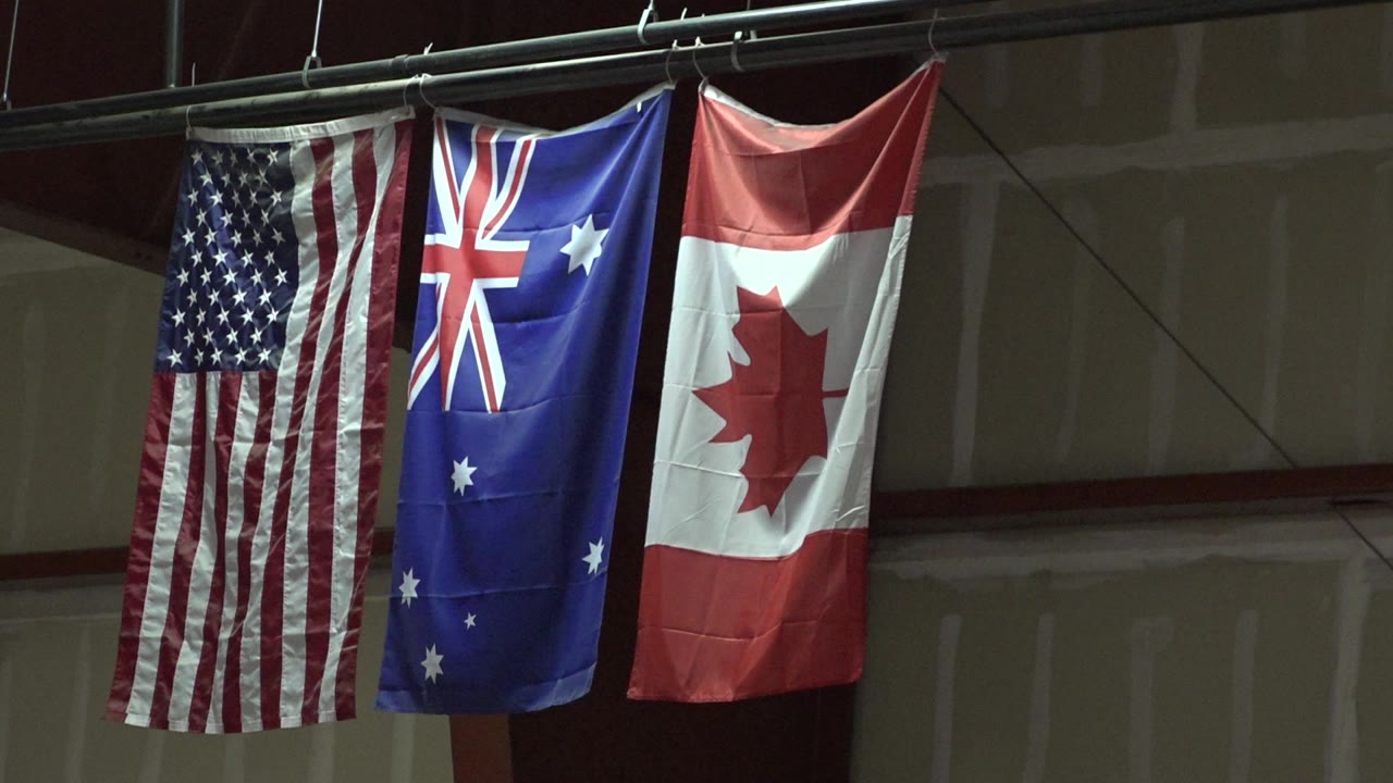 USA, Australia, and Canada flags hanging indoors