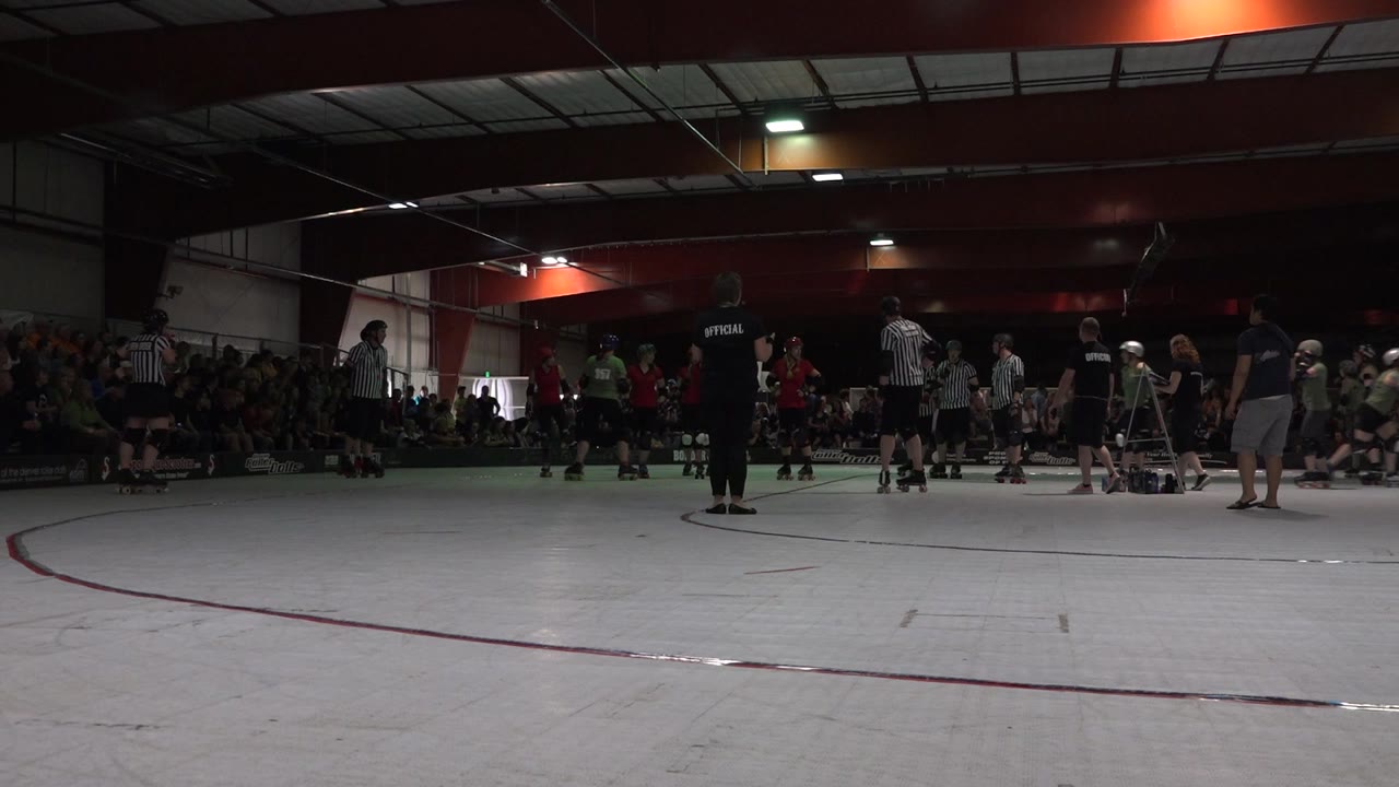 In Denver, Colorado, the group of roller skaters holds a loose circle shape while officials and spectators remain visible along the rink edge.