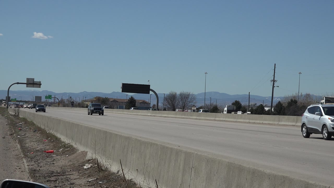 White SUV exits the right edge of the road frame.