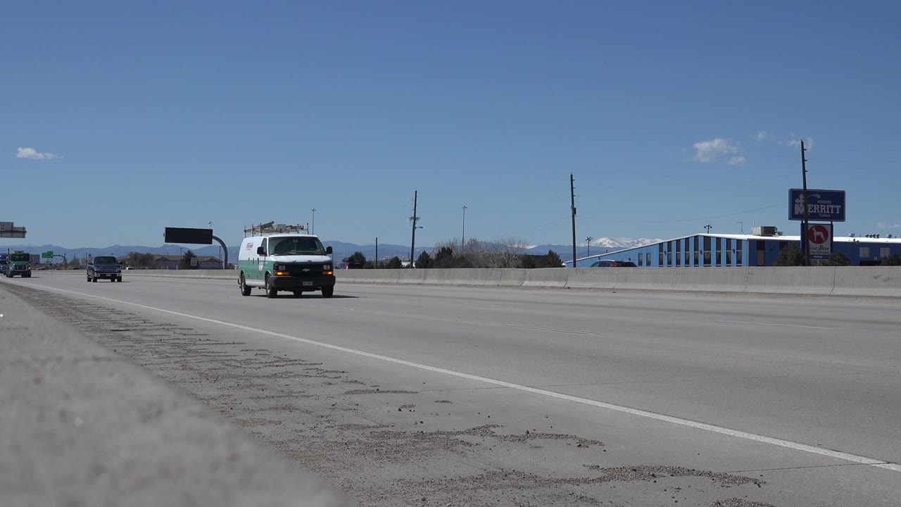 White and green van passing on a sunny highway