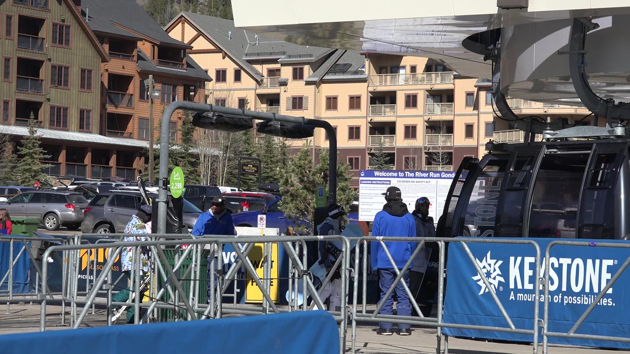Keystone gondola loading area with people by railings.