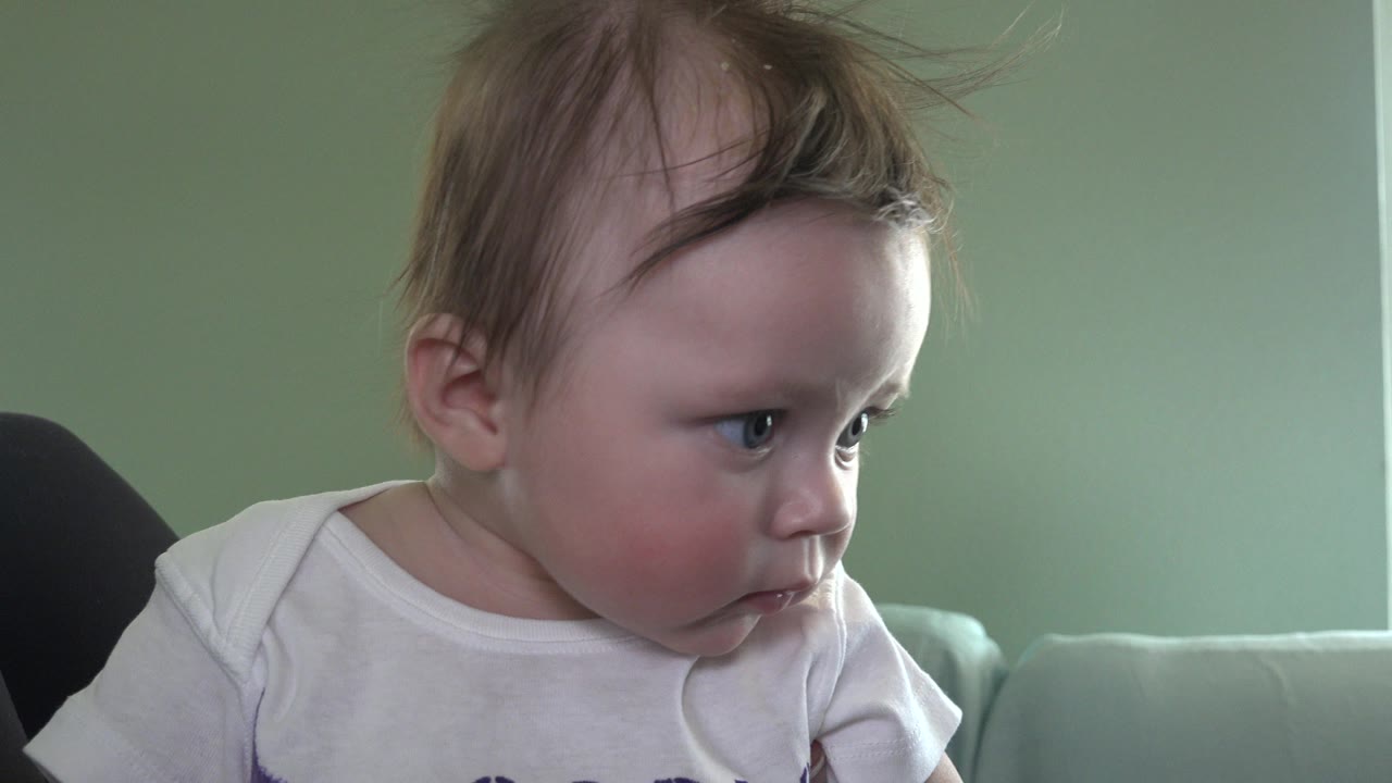 Baby on a couch looking to the right