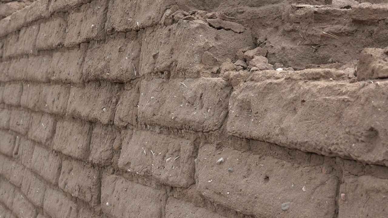 Close view of a rough brown brick wall
