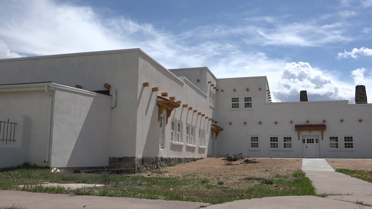 Second frame shows the Taos New Mexico exterior from nearly the same ground view, with the walkway centered toward double doors and no visible people.