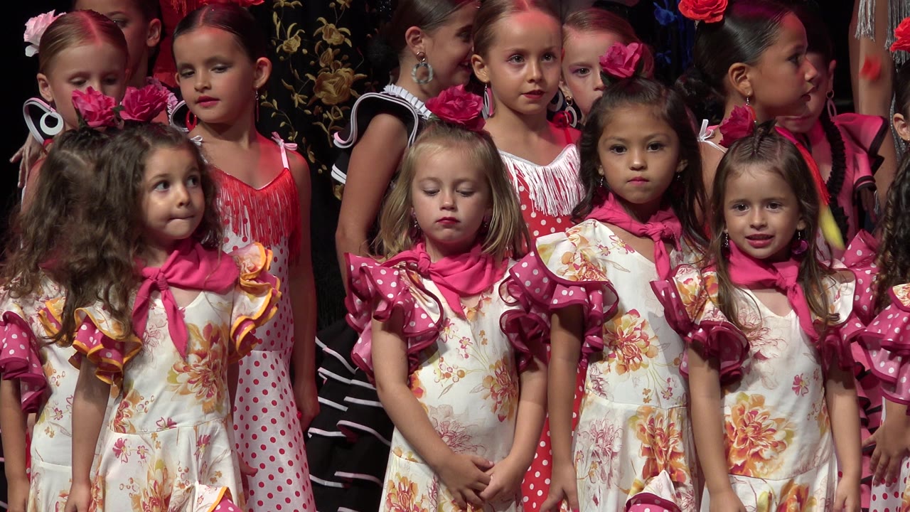 Children on stage with one girl looking sideways.