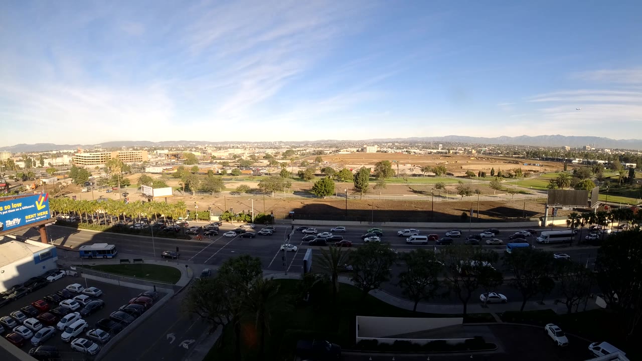 Busy road and parking lot seen from above in daylight