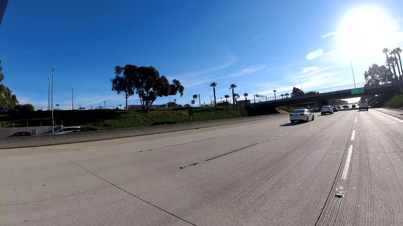 Open freeway with cars approaching an overpass