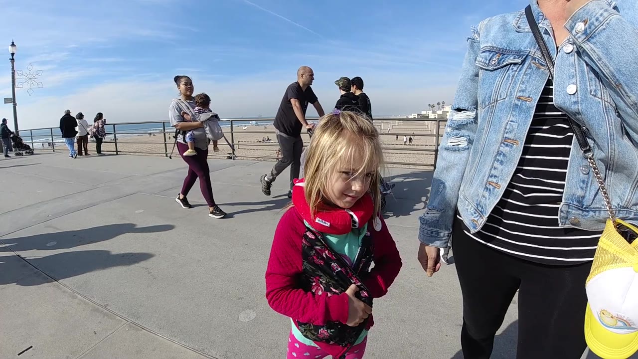 Child standing close to camera on seaside promenade