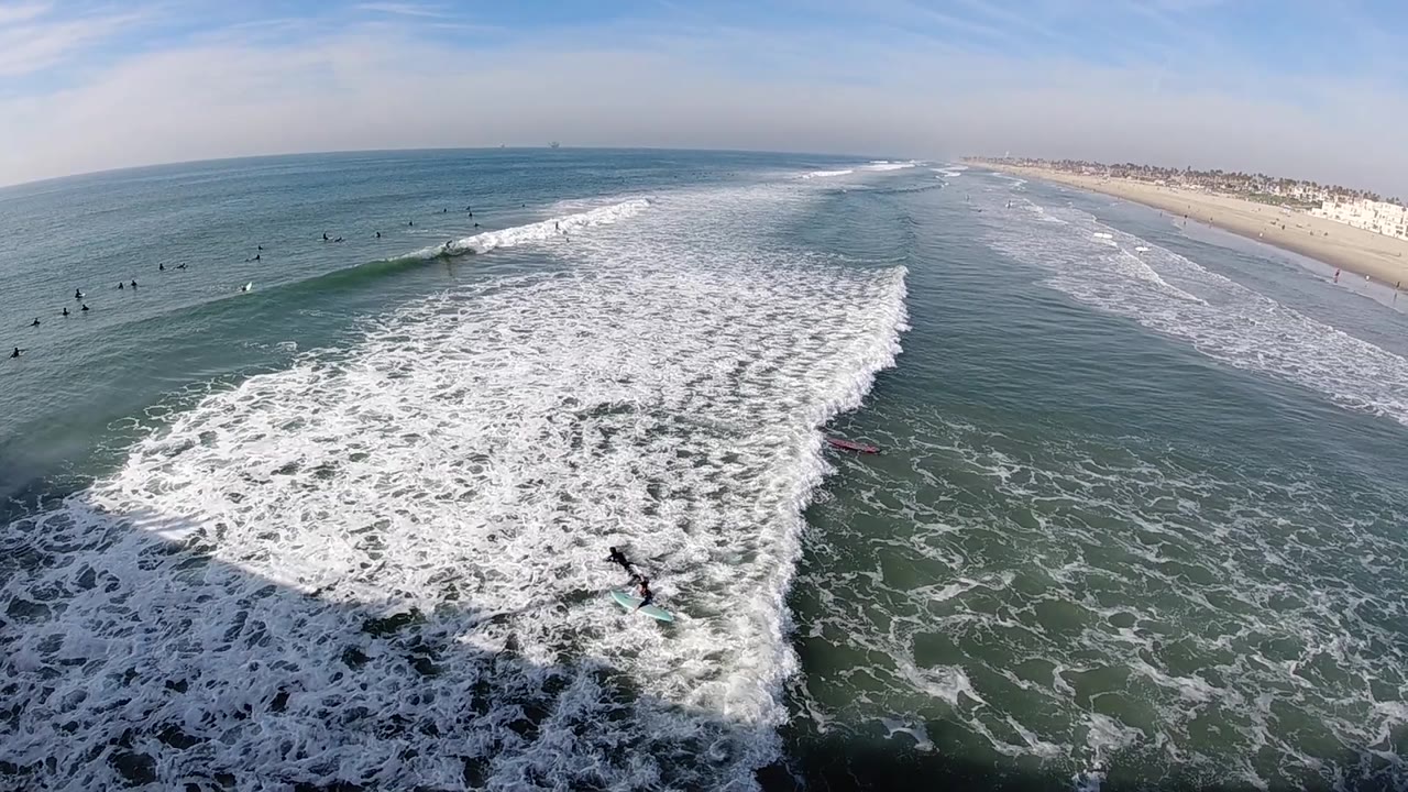 The third frame looks across Huntington Beach water as a broad white wave breaks toward the foreground while small surfers remain lined up beyond it.