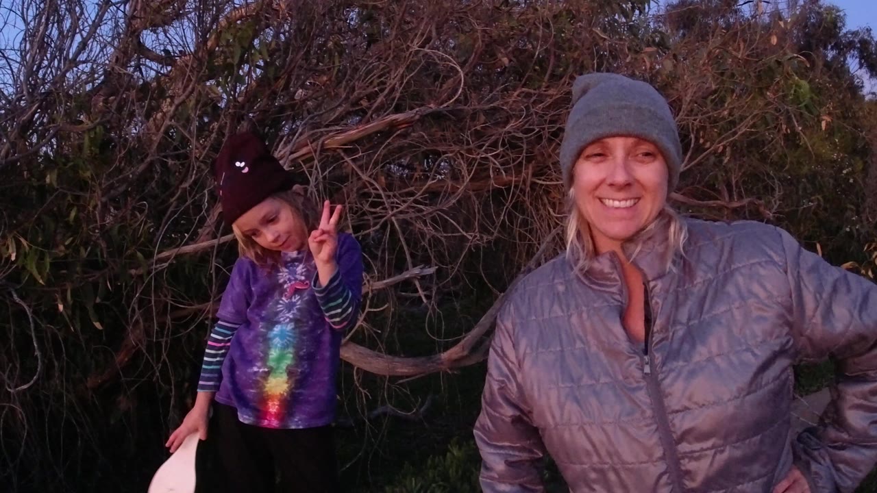 Woman and child posing, with child's paddle partly visible.