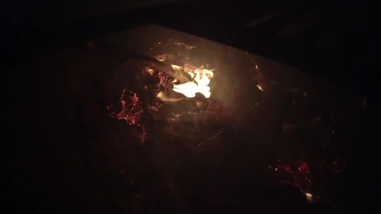 A wider flame spreads across the top of glowing red embers in the Ojai fire detail, with heavy black negative space and no visible people.