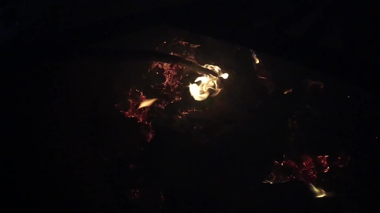 At 0:02, a pale flame curls across the upper right of the ember bed in Ojai, California, with no visible people.